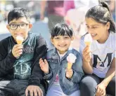  ??  ?? Eshan Imran, 7, Alisha Imran, 5 and Safina Saddiq, 10, have an ice cream