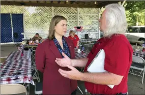  ?? AP PHOTO/DAVID EGGERT ?? Rep. Elissa Slotkin, D-Mich., talks with a constituen­t after a veterans event on Aug. 2 at the Ingham County Fair in Mason, Mich.