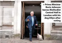  ?? ?? > Prime Minister Boris Johnson leaves Methodist Central Hall in London with his dog Dilyn after voting