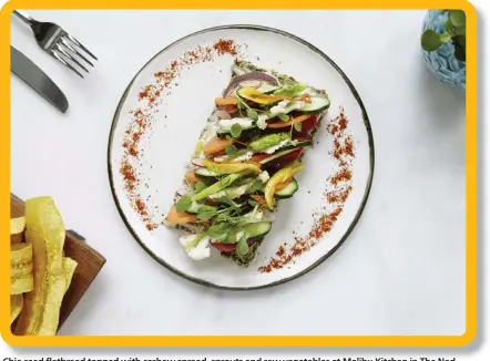  ?? Pictures: The Ned /The New York Times ?? Chia seed flatbread topped with cashew spread, sprouts and raw vegetables at Malibu Kitchen in The Ned hotel in London.