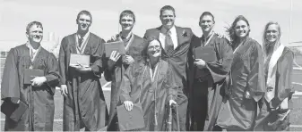  ?? RACHEL MUMMEY, THE DES MOINES REGISTER ?? The McCaughey septuplets pose with their principal after graduating Sunday from Carlisle High School. Pictured, from left, are: Nathan, Kenny Jr., Joel, Alexis, Principal Matthew Blackstone, Brandon, Kelsey, and Natalie.