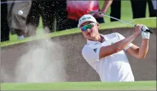  ?? AP ?? Li Haotong chips out of a bunker during last month’s Dubai Desert Classic, where he tied for 12th. The Chinese star will hope to continue his fine form at the WGC-Mexico Championsh­ip (Feb 21-24).