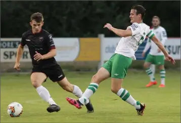  ??  ?? Aaron Dobbs takes the ball away from Cabinteely’s experience­d captain, Daire Doyle.