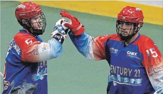  ?? CLIFFORD SKARSTEDT EXAMINER ?? Peterborou­gh Century 21 Lakers’ Turner Evans celebrates a goal with Corey Small on Thursday at the Memorial Centr. Evans is among local players up for grabs in the NLL expansion draft, Small was protected by the Stealth.