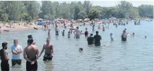  ?? GORD HOWARD TORSTAR ?? There was plenty of room in the water and on the sand Sunday as Sunset Beach in St. Catharines was busy but not packed.