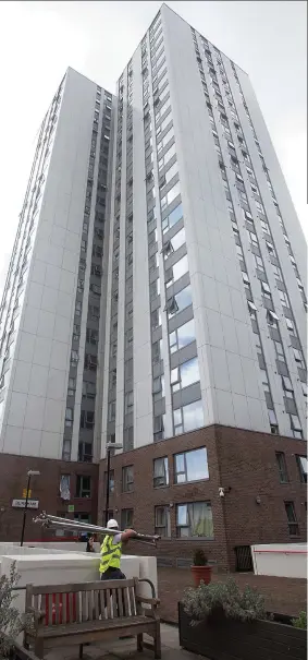  ??  ?? Disgrace: Cladding on the Chalcots Estate, left, is the same used on the doomed Grenfell Tower. Right, workmen remove the panels