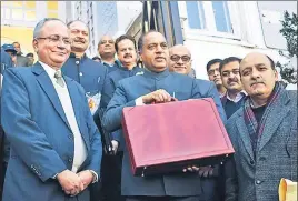  ?? ■ DEEPAK SANSTA/HT ?? Himachal chief minister Jai Ram Thakur along with finance department officials arriving to present the budget at the Himachal Pradesh Vidhan Sabha in Shimla on Saturday.