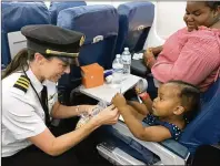  ?? DELTA AIR LINES ?? A Delta pilot greets passengers on a Bahamas relief flight. The airline’s volunteers flew into an uncertain situation immediatel­y after Hurricane Dorian devastated the islands to bring relief supplies in and to ferry evacuees out to Nassau.