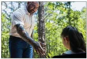  ?? ?? Former teacher turned soothsayer Leonard (Dave Bautista) congratula­tes young Wen (Kristen Cui) on the box office success of “Knock at the Cabin.” The low-budget sci-fi thriller came in at No. 1 with $14.2 million at U.S. and Canadian theaters last week.