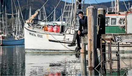  ?? BRADEN FASTIER/NELSON MAIL ?? Nelson fisherman Fin Horder with his boat Moata.