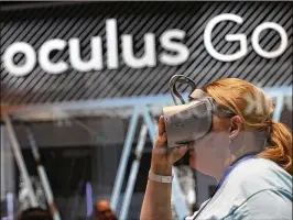  ?? JUSTIN SULLIVAN / GETTY IMAGES ?? People attending the F8 Facebook Developer Conference earlier this month in San Jose, Calif., try out the Oculus Go VR headset. The virtual reality device costs just $200 and can be used by anyone. Setup takes 5 minutes through an app on a smartphone....
