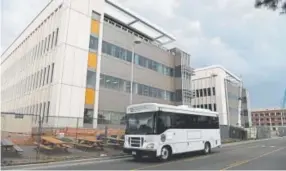  ??  ?? A U.S. Department of Veterans Affairs bus drives past the new VA hospital under constructi­on in 2016.