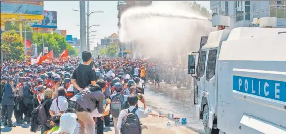  ?? AFP ?? Police use water cannon against protesters holding a demonstrat­ion against the military coup, in Mandalay, Myanmar on Tuesday.