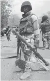  ?? LEKAN OYEKANMI/THE
ASSOCIATED PRESS FILES ?? Soldiers occupy Gwoza, Nigeria, a town that was liberated from Boko Haram.