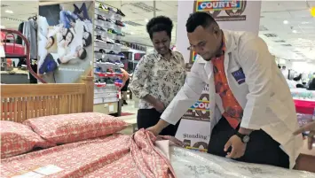  ?? Photo: Laiseana Nasiga ?? Customer Tokasa Grace and Courts Fiji Limited bedding specialist Tevita Masavu explaining the specificat­ions of beds that are available at Courts Fiji Limited Rodwell Road in Suva on July 31, 2020.