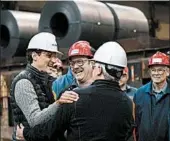  ?? JUSTIN TANG/AP ?? Canadian Prime Minister Justin Trudeau, left, meets with workers at Essar Steel Algoma in Sault Ste. Marie, Ontario.