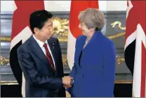  ?? PICTURE: AP ?? British Prime Minister Theresa May, right, shakes hands with her Japanese counterpar­t Shinzo Abe in Tokyo.