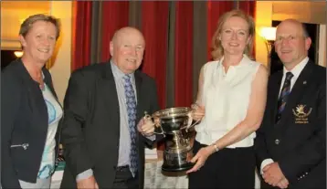  ??  ?? Runners-up in the Club Mixed Foursomes Competitio­n (Wickham Trophy) at Laytown & Bettystown Golf Club, Barbara and Eamon Cooney, are presented with their prizes by Carol Wickham and Captain Denis Taylor.