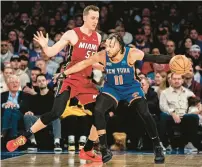  ?? PETER K. AFRIYIE/AP ?? New York Knicks guard Jalen Brunson posts up as Miami Heat forward Duncan Robinson defends during the first half on Saturday in New York.