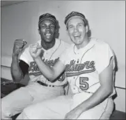  ??  ?? FILE - In this Oct. 5, 1966, file photo, Baltimore Orioles teammates Frank Robinson, left, and Brooks Robinson pose after leading the Baltimore Orioles to a 5-2 win in the opening game of the World Series against the Los Angeles Dodgers, in Los Angeles. Hall of Famer Frank Robinson, the first black manager in Major League Baseball and the only player to win the MVP award in both leagues, has died. He was 83.