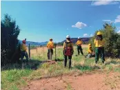  ?? COURTESY OF US FOREST SERVICE ?? U.S. Forest Service crews repair fences on private land that were damaged during firefighti­ng efforts against the Calf Canyon/Hermits Peak Fire.