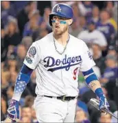  ?? HARRY HOW/GETTY ?? Dodgers catcher Yasmani Grandal strikes out with the bases loaded during the ninth inning of Monday’s loss.