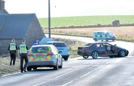  ?? Picture: Chris Sumner. ?? Police at the scene of the collision that closed the A92 between Dunnottar and Inverbervi­e.