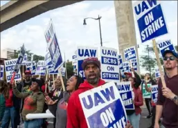  ?? Matthew Hatche/ AFP via Getty Images ?? Blue Cross Blue Shield employees show their support to members of the United Auto Workers (UAW) union as they march through the streets of downtown Detroit, Sept. 15.