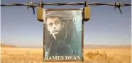  ?? (Reuters/File Photo) ?? A portrait of U.S. actor James Dean hangs from a fence near the intersecti­on of Highways 46 and 41 near Cholame, California