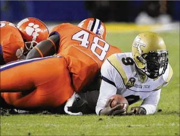  ?? AJC 2009 ?? Georgia Tech’s Joshua Nesbitt is tackled in the 2009 ACC Championsh­ip game Tech won 39-34 over Clemson in Tampa, Florida. Tech’s title later was taken away by the NCAA because of what where in hindsight minor violations.