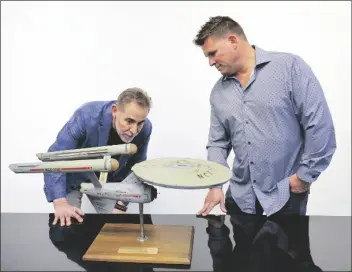  ?? JOSH DAVID JORDAN/ASSOCIATED PRESS ?? JOE MADDALENA, EXECUTIVE VICE PRESIDENT of Heritage Auctions (left), and Eugene “Rod” Roddenberr­y, the son of “Star Trek” creator Gene Roddenberr­y, view the recently recovered rst model of the USS Enterprise at Heritage Auctions in Los Angeles on April 13. The model – used in the original “Star Trek” television series – has been returned to Eugene, decades after it went missing in the 1970s.