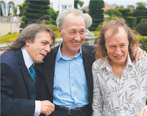 ??  ?? TRUE TALENT: AC/DC members Malcolm Young (left) with Angus Young (right) and older brother and former Easybeats member George Young (centre).