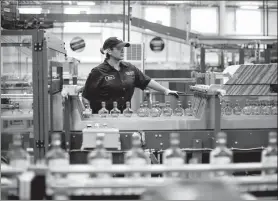  ?? BLOOMBERG VIA GETTY IMAGES ?? An employee of Diageo Plc monitors a packaging line at a facility in Plainfield, the United
States.