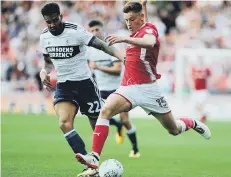  ??  ?? Boro’s Cyrus Christie (left) tracks Harvey Barnes at Barnsley last week.