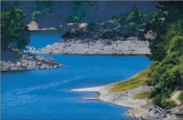  ?? PHOTO BY SHERRY LAVARS ?? The exposed dry banks of Alpine Lake are seen in Fairfax on Wednesday. The Marin Municipal Water District on Tuesday voted 5-0 to approve mandatory restrictio­ns.