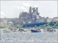  ?? CANADIAN PRESS FILE PHOTO ?? Fishing boats pass the Northern Pulp mill as concerned residents, fishermen and Indigenous groups protest the mill’s plan to dump millions of litres of effluent daily into the Northumber­land Strait in Pictou this summer.