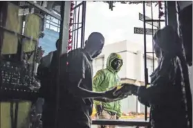  ??  ?? Spirit of volunteeri­sm: Sifiso Ntuli (left) is the co-owner of the Roving Bantu Kitchen (right). During the lockdown, the eatery is running a soup kitchen to feed people living in Brixton and the neighbouri­ng suburb of Fietas. Photos: Paul Botes