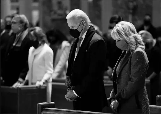  ?? EVAN VUCCI / AP ?? Then-president-elect Joe Biden and his wife, Jill Biden, attend Mass Jan. 20 at the Cathedral of St. Matthew the Apostle during Inaugurati­on Day ceremonies in Washington. Biden’s decision to partake in Communion continues to be a point of contention among Catholic bishops because of his support of abortion rights.