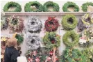  ?? BRYNN ANDERSON/ASSOCIATED PRESS ?? Holiday wreaths are displayed for sale at a retail store in Pembroke Pines, Fla. Consumer confidence fell slightly for a fourth straight month.