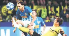  ??  ?? Atletico Madrid’s Diego Godin in action with Borussia Dortmund’s Mario Goetze during the Champions League Group A match at Signal Iduna Park in Dortmund, Germany. — Reuters photo