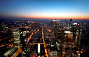  ??  ?? The sun sets behind the financial district early evening in Frankfurt, Germany. — Reuters photo