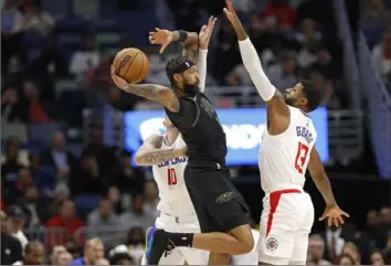  ?? Tyler Kaufman/Associated Press ?? Pelicans forward Brandon Ingram passes the ball as Clippers forward Paul George defends during the first half Friday in New Orleans.