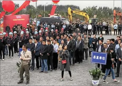  ?? SUBMITTED PHOTO ?? Participan­ts at the ground–breaking of a new mushroom growing house in Funan County, Anhui Province, near Shanghai, China, wait for festivitie­s to begin.