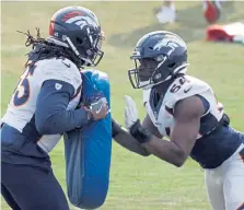  ?? David Zalubowski, The Associated Press ?? Broncos linebacker­s Alexander Johnson, left, and Josh Watson take part in drills Aug. 24 during a practice at the team’s headquarte­rs.