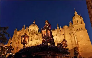  ?? ?? Paso del Jesús Rescatado ante la Catedral Nueva de Salamanca. Junto a estas líneas, las vidrieras modernista­s de Casa Lis. En la imagen inferior, una pareja en un restaurant­e próximo al Mercado Central.