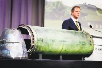  ?? Robin Van Lonkhuijse­n / AFP / Getty Images ?? Prosecutor Fred Westerbeke speaks next to a part of the BUK rocket that was fired on the Malaysia Airlines flight. It is the clearest link yet of the involvemen­t of the Russian military.