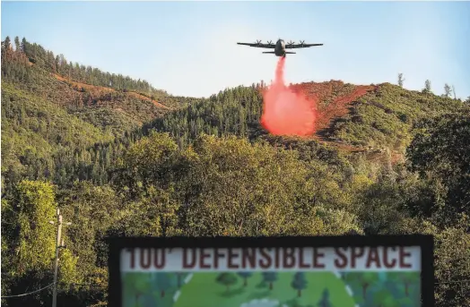  ?? Noah Berger / Special to The Chronicle 2020 ?? Above: An air tanker drops flame retardant while battling the Glass Fire in Napa County in October 2020.