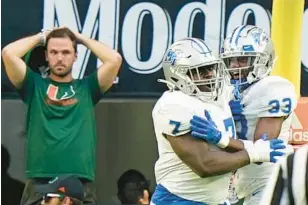  ?? WILFREDO LEE/AP ?? Middle Tennessee defensive tackle Zaylin Wood (7) celebrates with cornerback Decorian Patterson (33) after Wood intercepte­d the ball and scored during the first half against Miami on Saturday. Middle Tennessee State beat Miami 45-31.