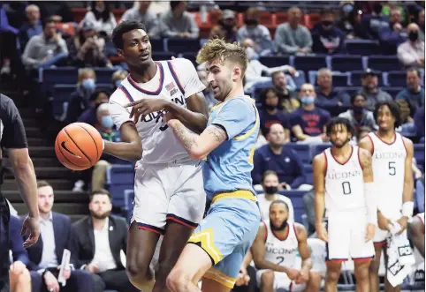  ?? Paul Connors / Associated Press ?? UConn’s Samson Johnson, left, passes around Long Island’s Jake Cook on Nov. 17 in Storrs.