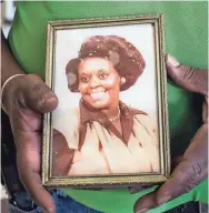  ??  ?? Lou Martin, owner of Uncle Lou’s Fried Chicken, holds a portrait of his mother, Mary Martin, who passed down her grandmothe­r’s recipe for fried chicken. PHOTOS BY BRAD VEST/THE COMMERCIAL APPEAL